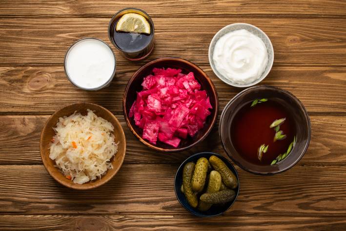 different fermented foods in jars and bowls