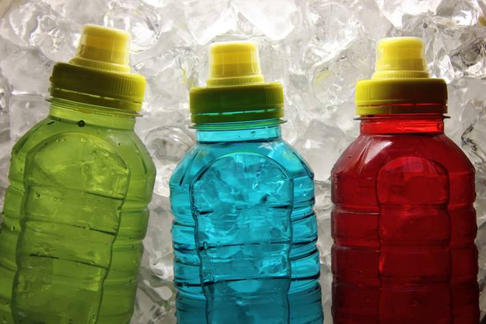 sport bottles with colored liquid inside them