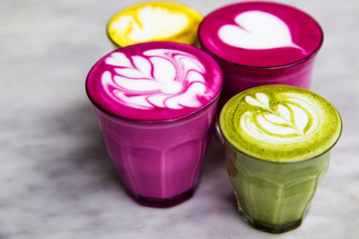 Beetroot, matcha,turmeric lattes are on the marble table.