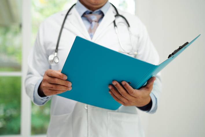 a doctor reading a report on a medical study