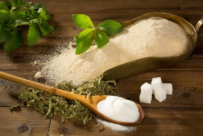 stevia leaves, cubes, and a scoop of sweetening powder