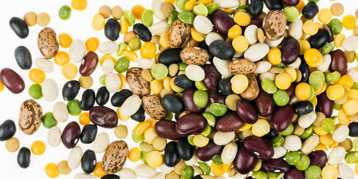 a pile of different beans, legumes, and seeds