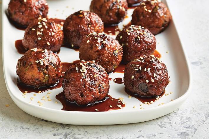 Asian Turkey Meatballs with Sweet Soy Dipping Sauce on a white platter ready to serve.