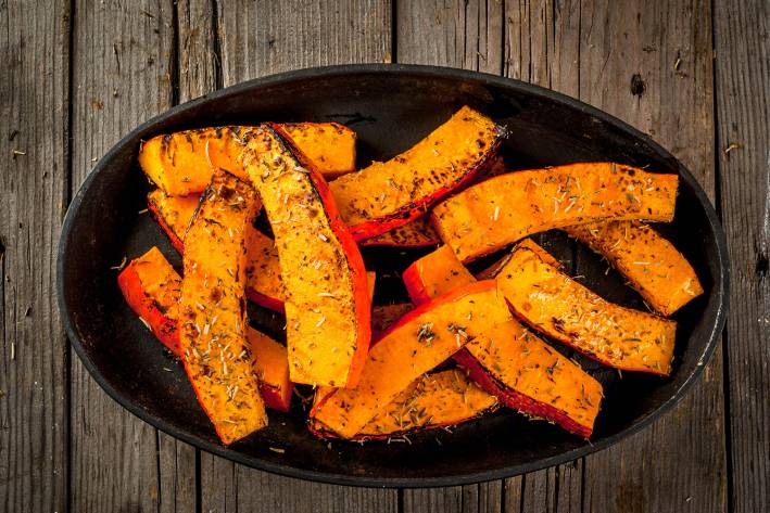 a bowl of seasoned pumpkin wedges