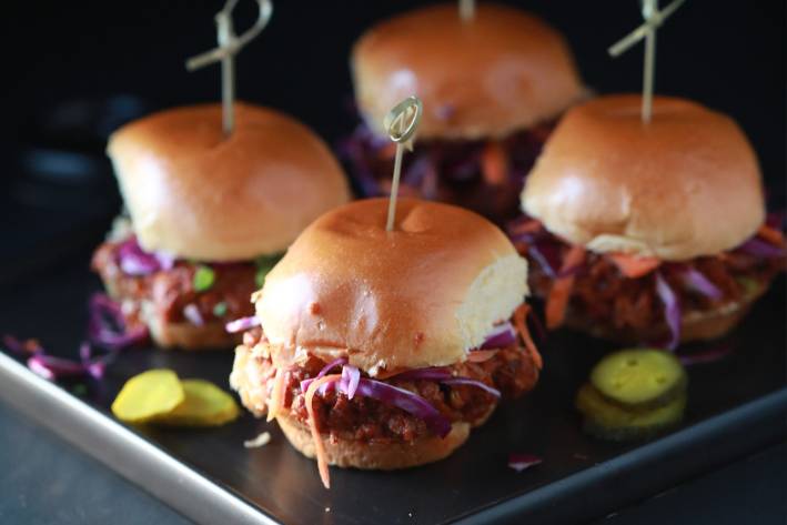 Turkey Lentil Sloppy Joes with Quick Cabbage Slaw on a black & silver serving tray.