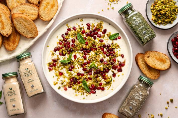 Whipped Feta Dip with Honey colorful dip with bottles of spices and bread