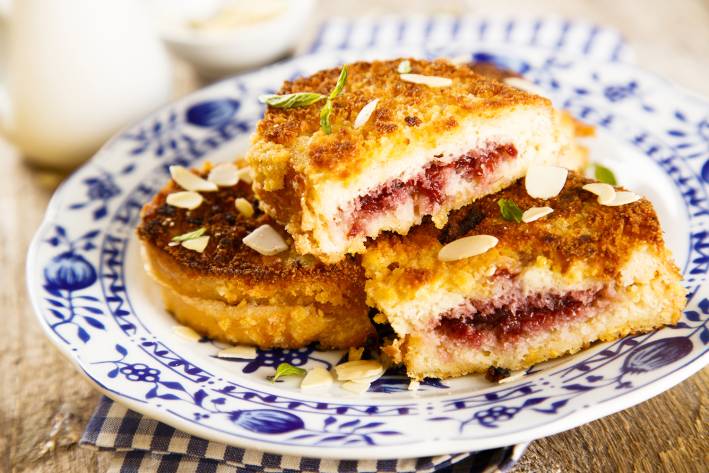 french toast with almonds and a cranberry sauce