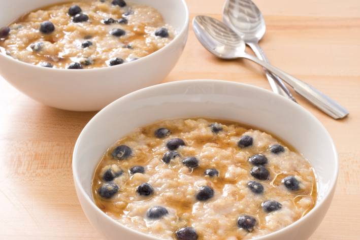 Delicious healthy bowls of ancient grain oatmeal with blueberries