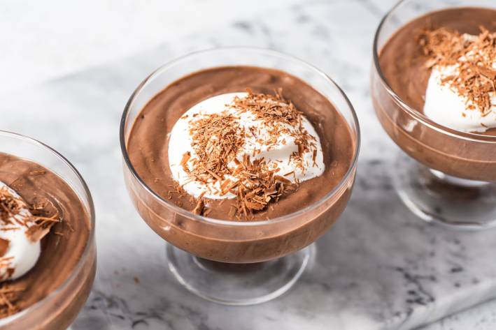 dishes of chocolate mousse with cream and shavings