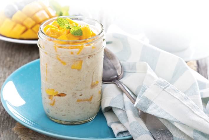 Mango coconut rice pudding in a glass cup