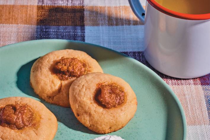 a plate of sugar cookies with dollops of pumpkin pie filling