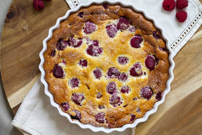 a freshly-baked raspberry clafoutis in a pan