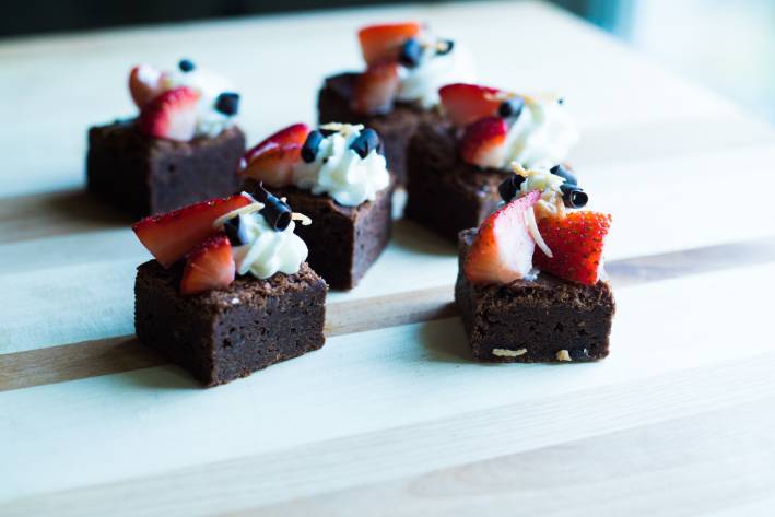 Miniature brownies topped with berries