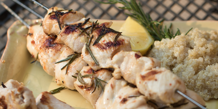 chicken skewers with rosemary on a grill