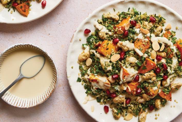 a plate of squash salad and a dish of tahini