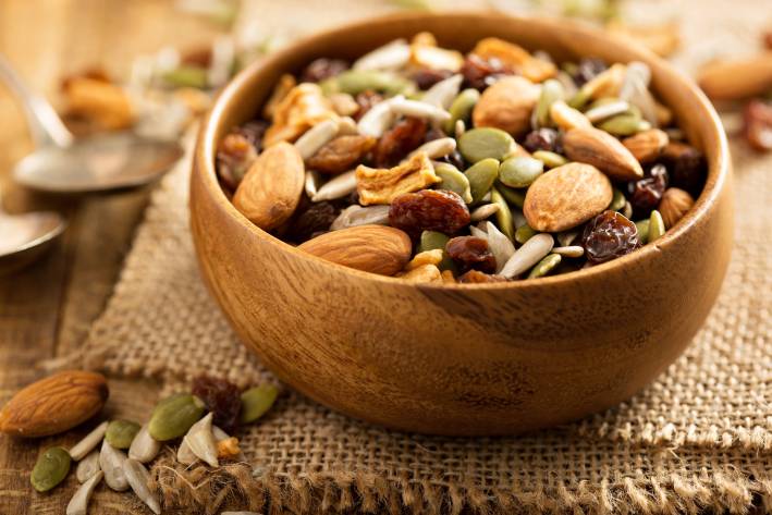 Trail mix in a wooden bowl. 