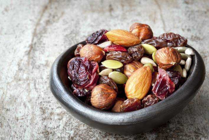 Trail mix in a small black bowl. 