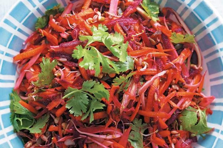 a bowl of salad with carrots, beetroots, and fennel