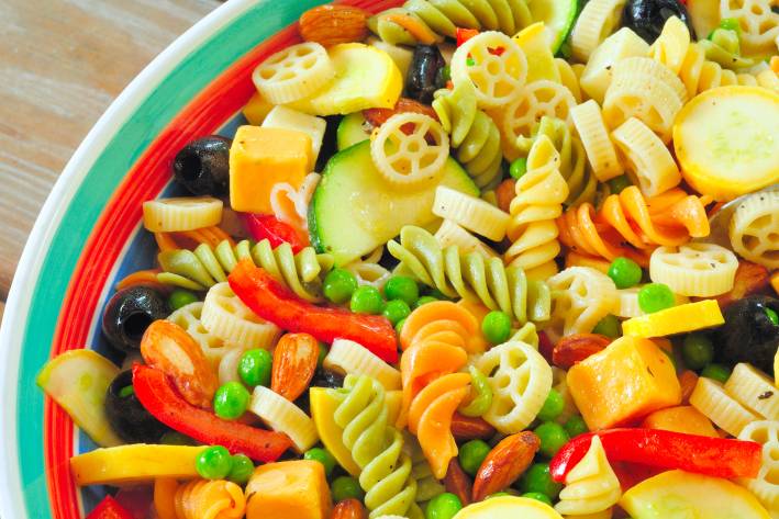 a bowl of pasta tossed with summer veggies