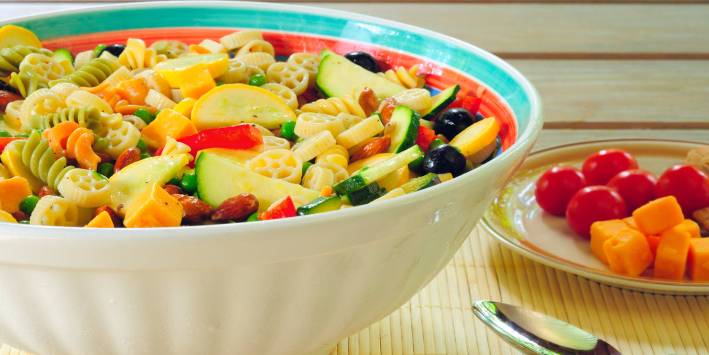 A bowl of pasta salad with veggies