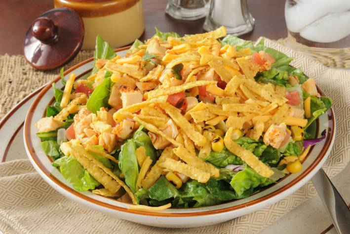 a bowl of taco salad with tortilla strips