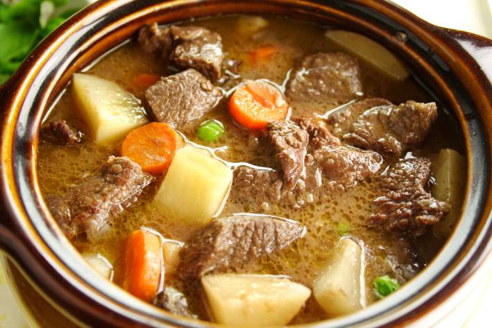 Rich hearty oven beef stew simmering and ready to serve.