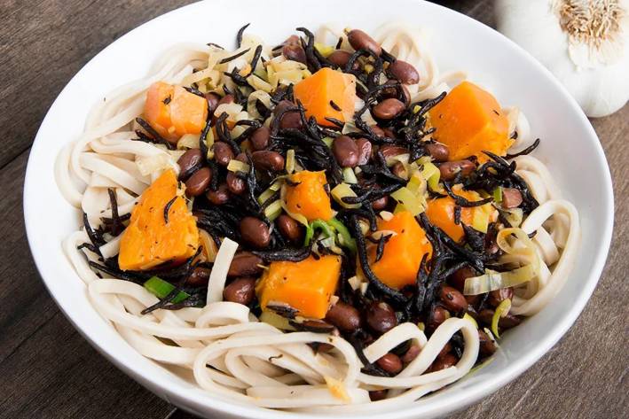 black beans and sweet potatoes on a bed of soba noodles