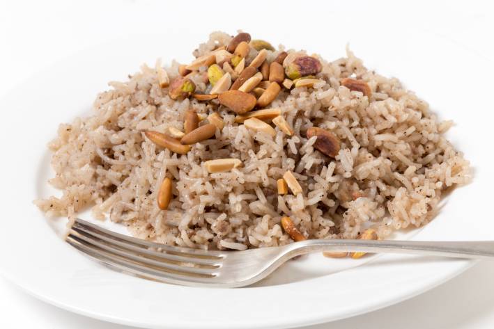 a plate of seasoned rice with almonds