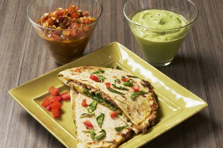 a healthy quesadilla with salsa and guacamole