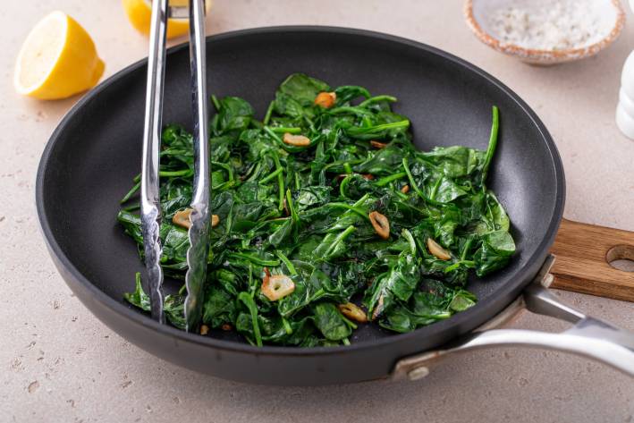 Sautéed garlic spinach in a pan. 