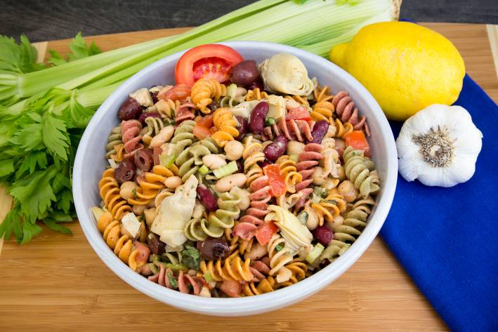 A bowl of three-bean pasta salad with vegetables