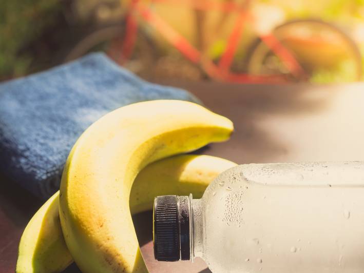  Gym workout accessory close up bottle of cool drinking water and banana.