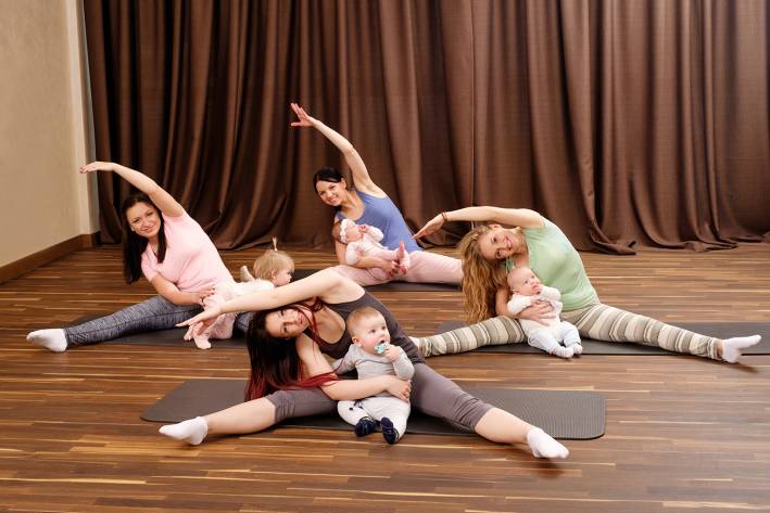 Young mothers in a fitness studio with their babies