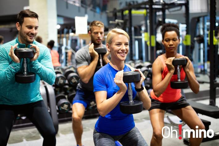 a group of happy people working out to build muscle
