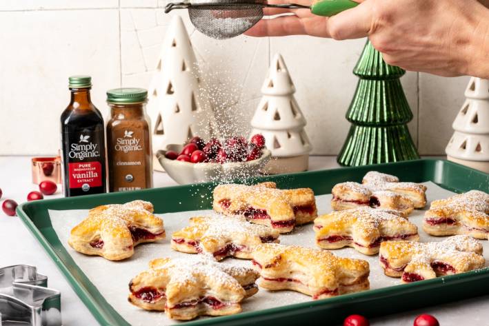 Cranberry Puff Pastry Cutouts cookies on a baking sheet - festive background