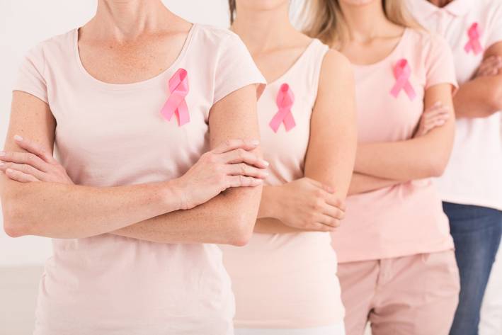 a row of proud breast cancer survivors