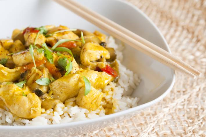 a bowl of curried chicken on jasmine rice
