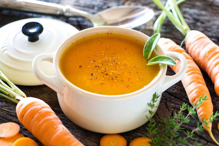 a bowl of fresh raw carrot soup