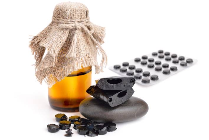 shilajit, a bottle of tincture, and tablets