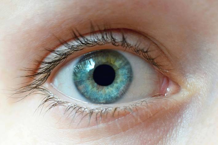 A close-up of a woman's clear blue eye