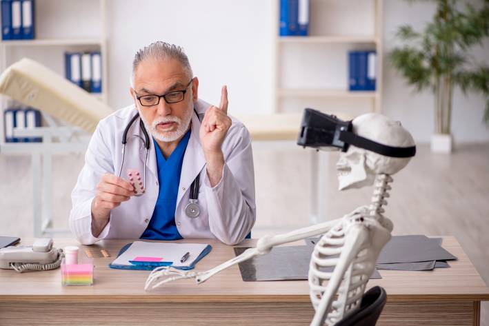 a doctor recommending supplements to a skeleton