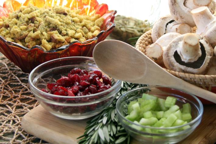 Ingredients to make healthy Thanksgiving side dishes, cranberries, bread for stuffing, celery and mushrooms.