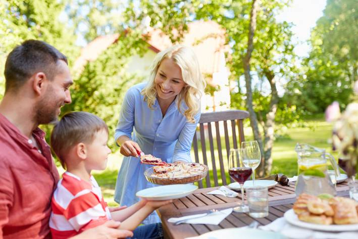 a mother serving her family pie at a cookout