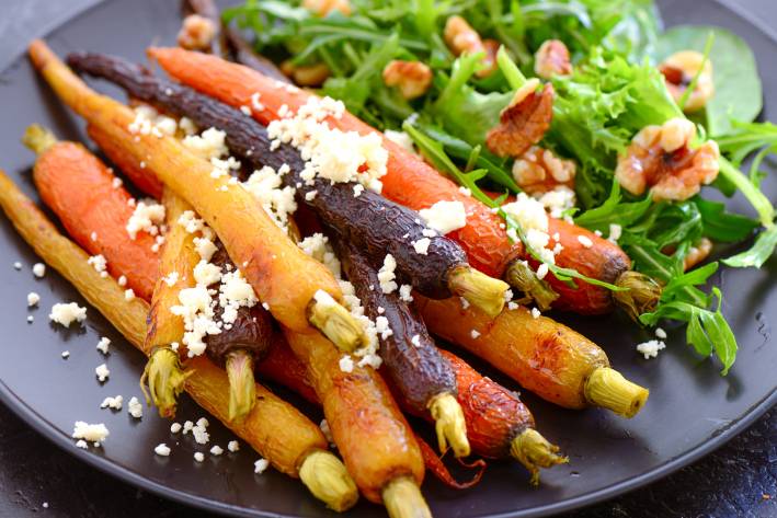 braised baby carrots and greens with cheese and nuts