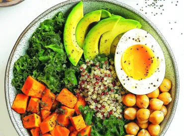 Kale, quinoa, chickpea and sweet potato salad in a bowl.