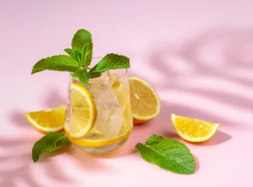 Glass of seltzer with fruit and mint. 