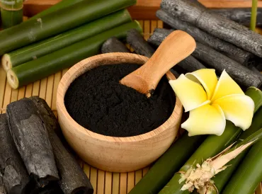 Activated Charcoal in a wooden bowl.
