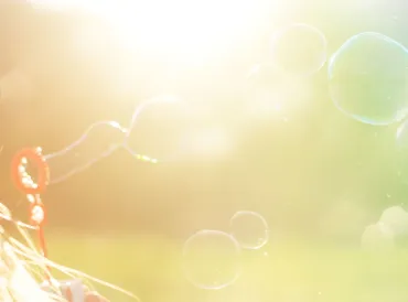 blowing bubbles in the summer sun