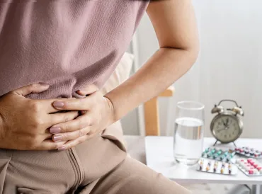 a woman clutching her abdomen in pain