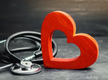 a wooden heart and a stethoscope